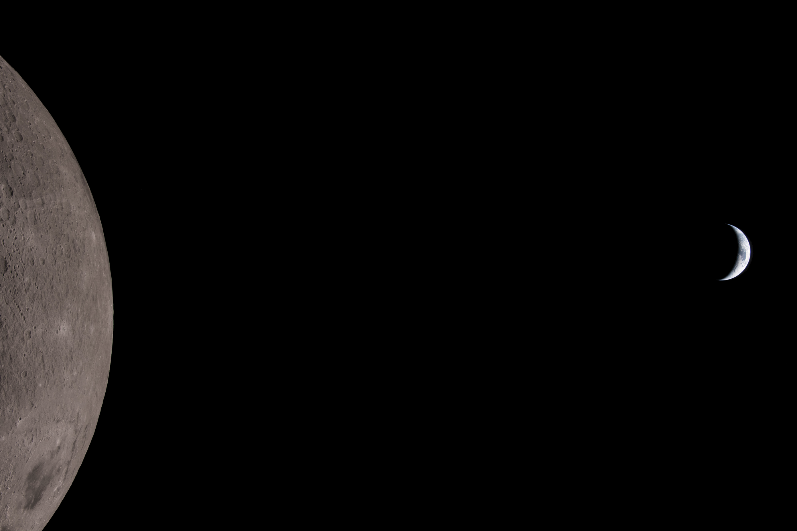 Wide view of the Moon at the far left and a tiny crescent Earth at the far right separated by black space